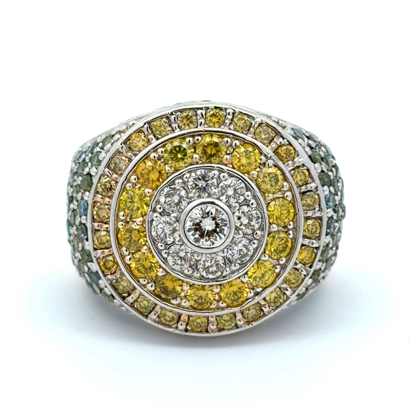 White gold ring with yellow, white, blue, & green diamonds on a white background
