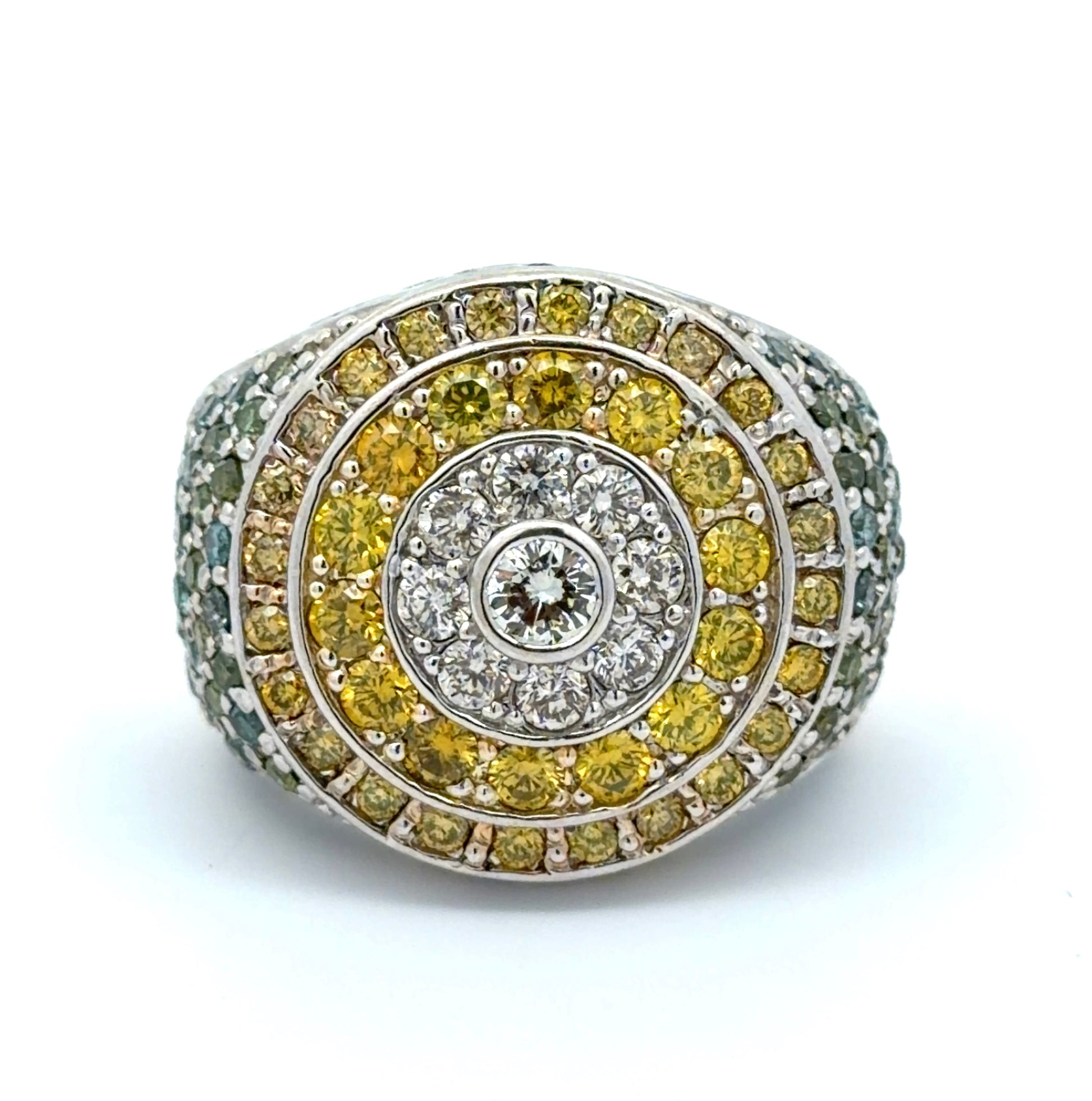 White gold ring with yellow, white, blue, & green diamonds on a white background