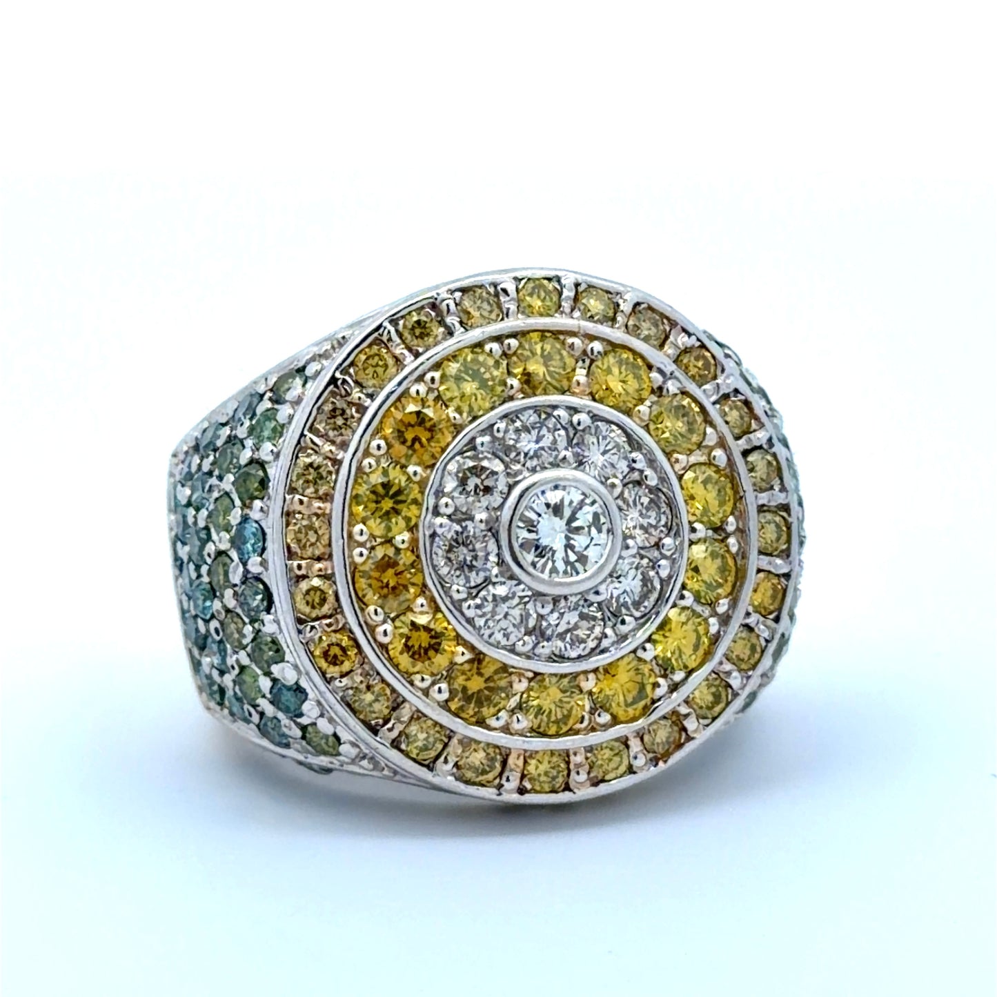 White gold ring with yellow, white, blue, & green diamonds on a white background