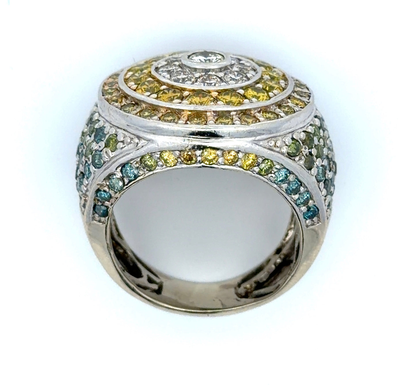 White gold ring with yellow, white, blue, & green diamonds on a white background