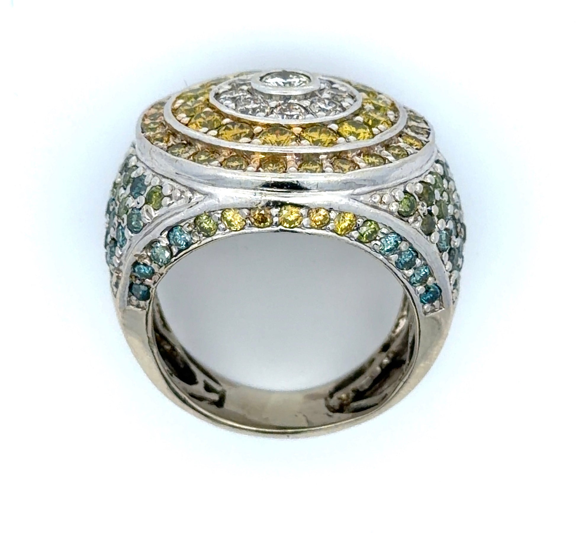 White gold ring with yellow, white, blue, & green diamonds on a white background