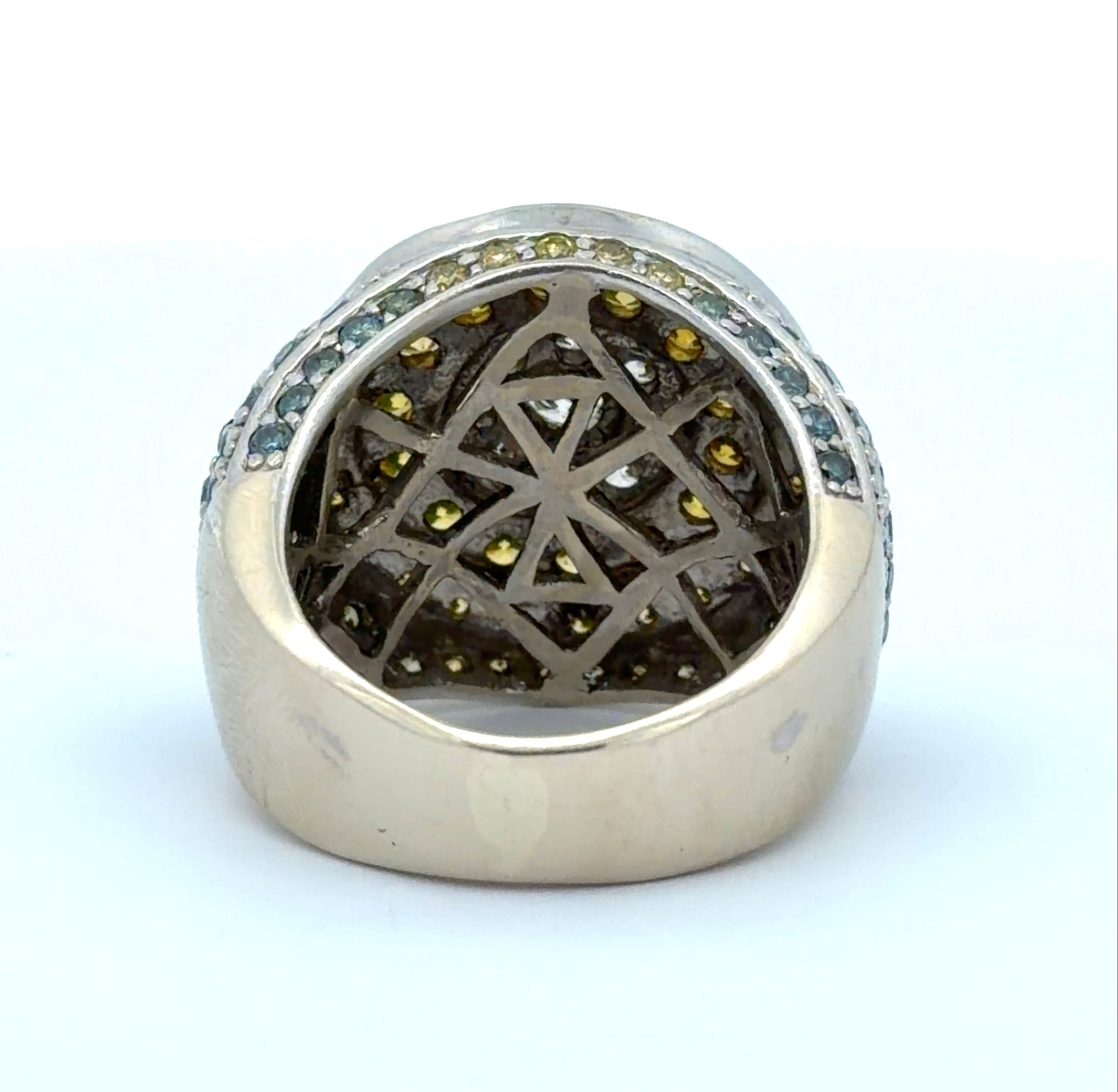 Back of white gold ring with yellow, white, blue, & green diamonds on a white background
