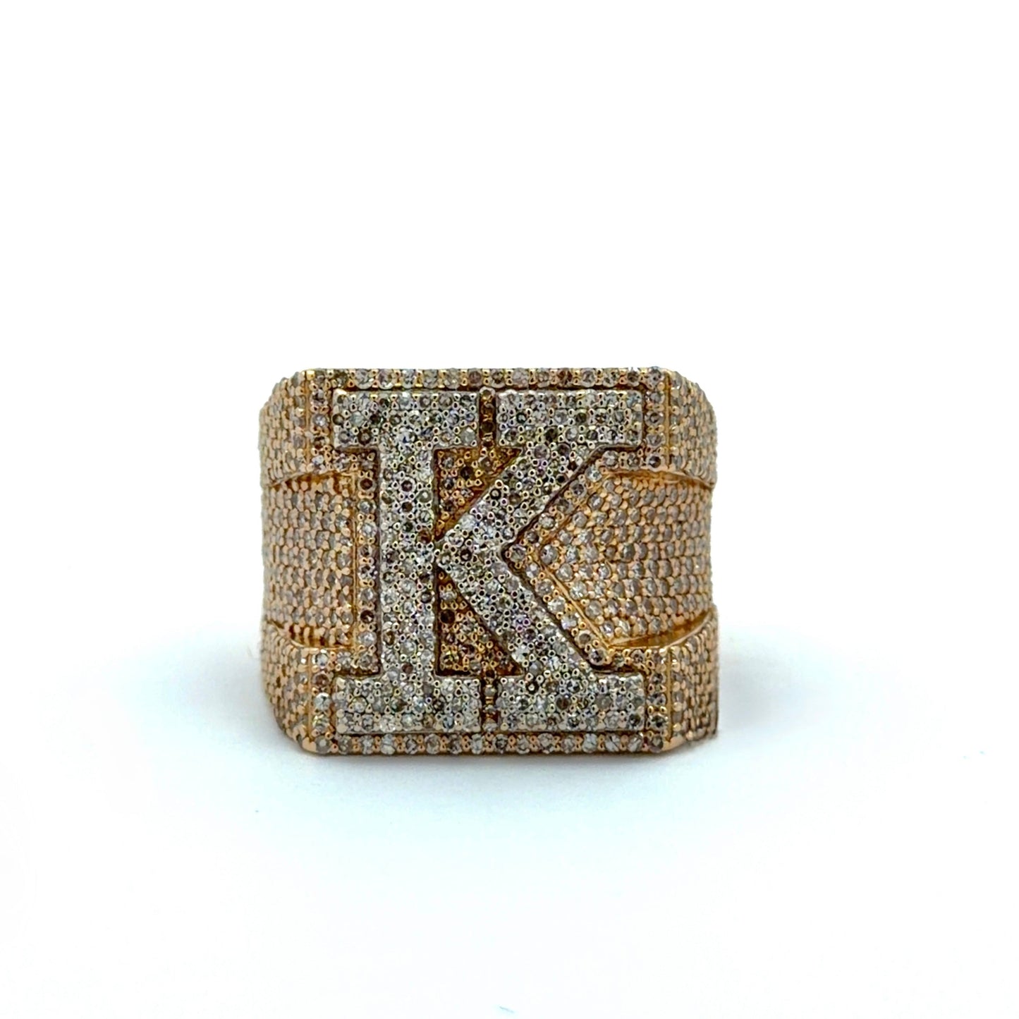 Gold and diamond-encrusted ring with a prominent 'K' on a white background