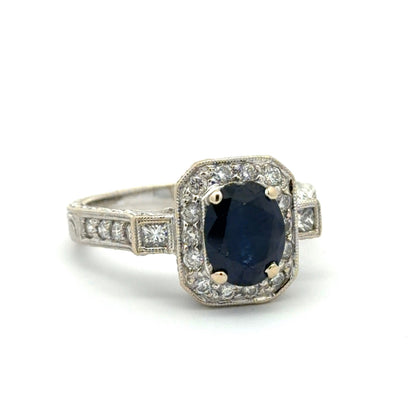 White gold ring with a blue gemstone and diamond accents on a white background