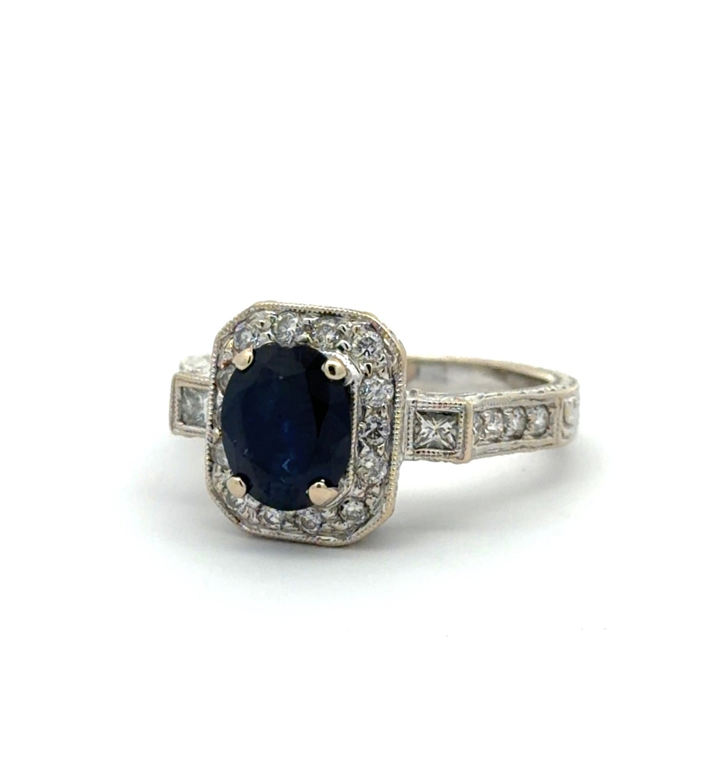 Ring with a blue gemstone and diamond accents on a white background