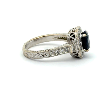 White gold ring with a blue gemstone on white background. 