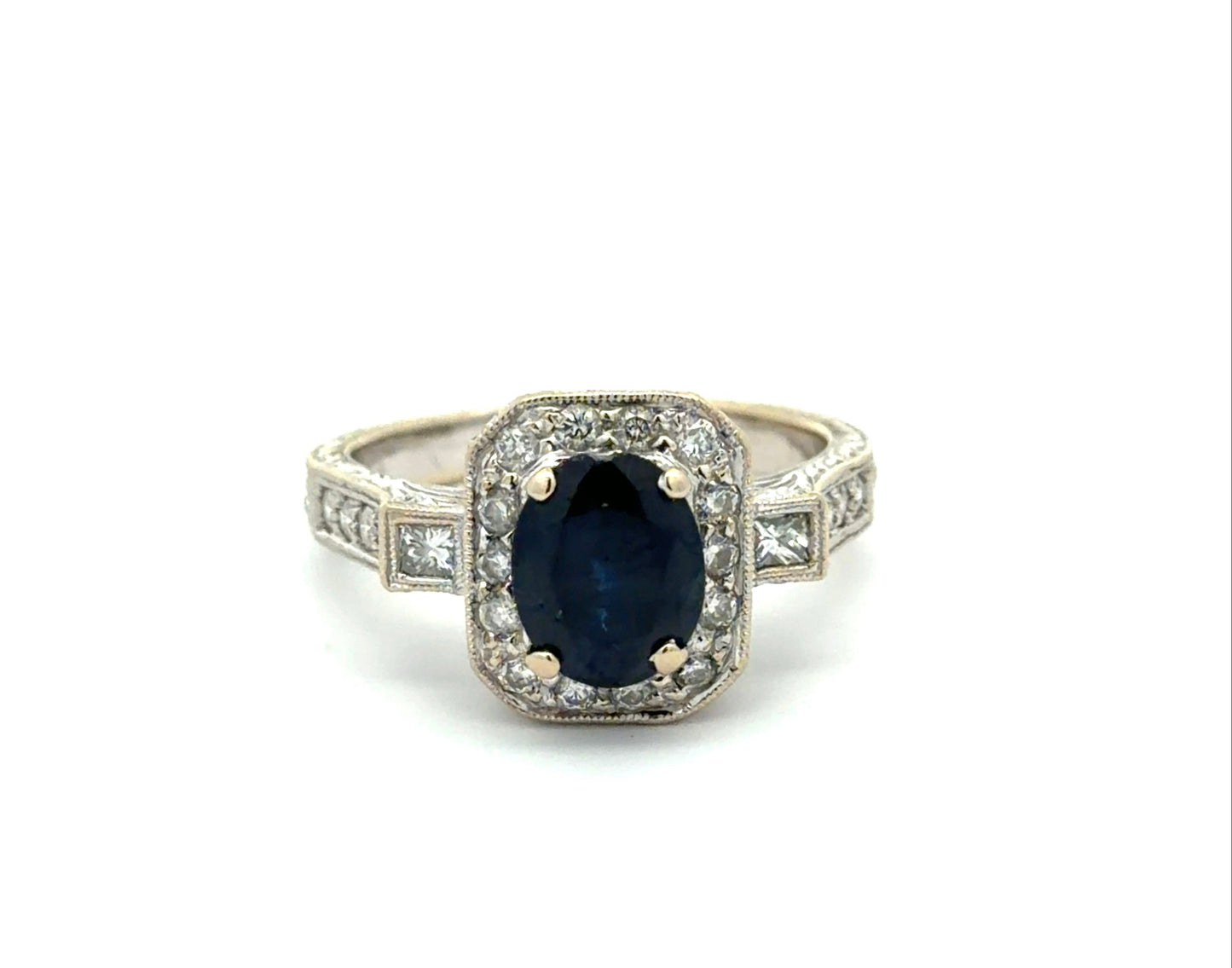 White gold ring with a blue gemstone and diamond accents on a white background