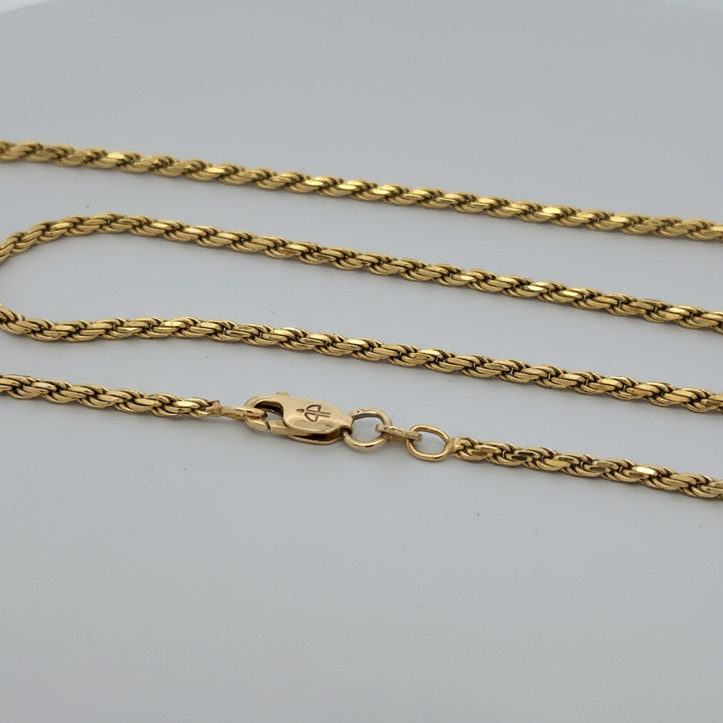 Gold chain necklace on a white background