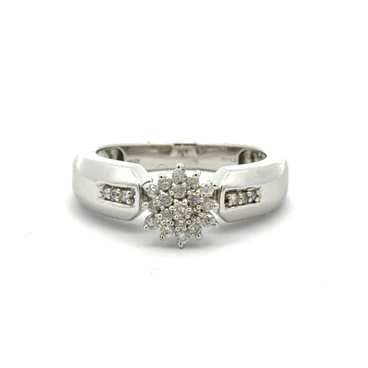 White gold ring with a diamond flower design on a white background