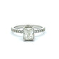 Diamond ring with a rectangular center stone on a white background