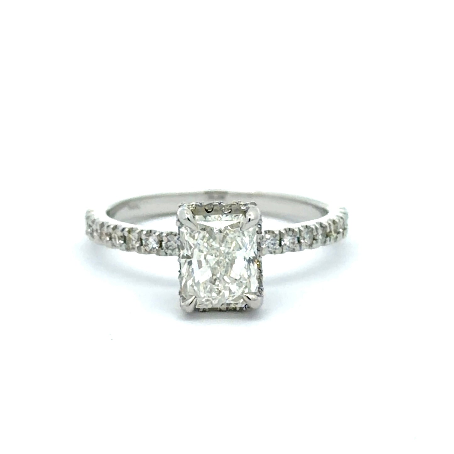 Diamond ring with a rectangular center stone on a white background