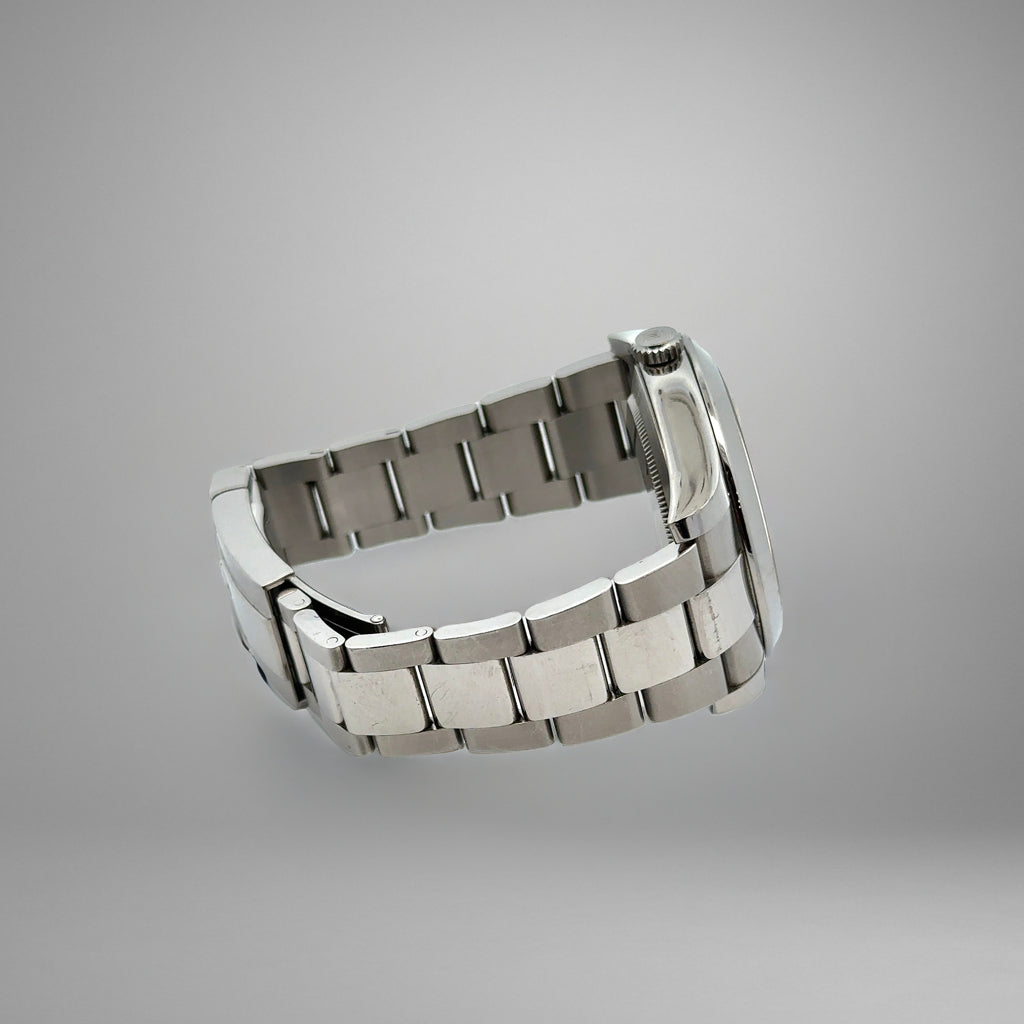 Silver metal watch strap on a gray background