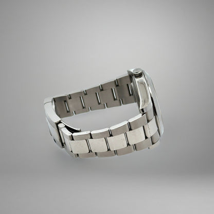 Silver metal watch strap on a gray background