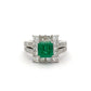Ring with a green gemstone and diamond accents on a white background