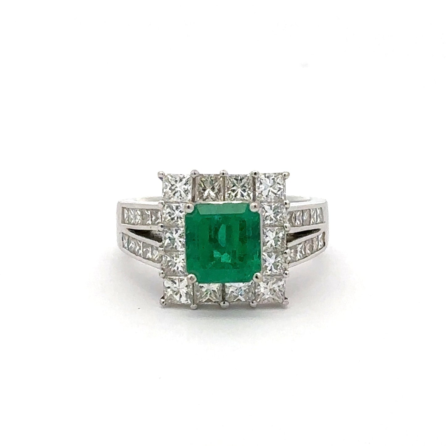 Ring with a green gemstone and diamond accents on a white background