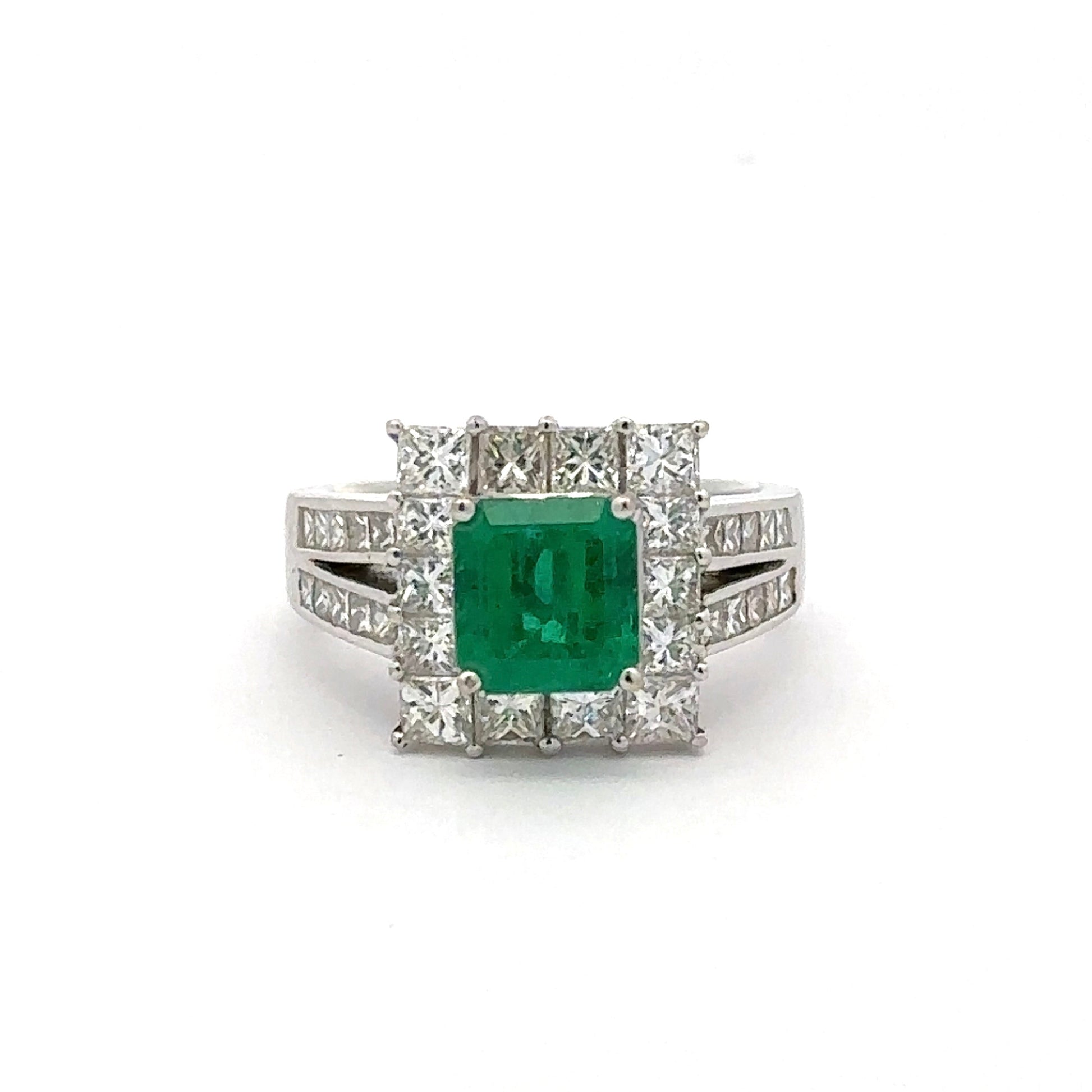 Ring with a green gemstone and diamond accents on a white background