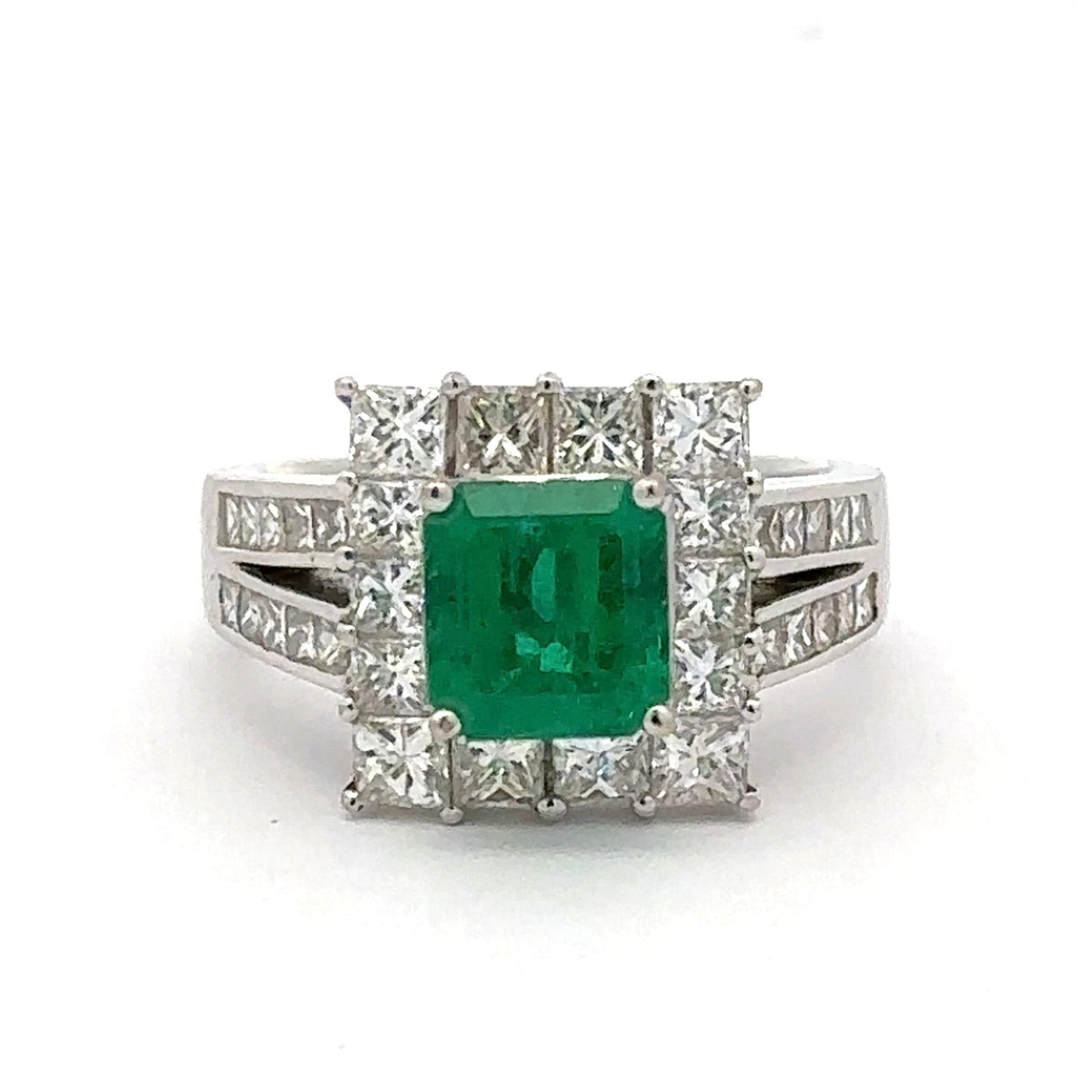 Ring with a green gemstone and diamond accents on a white background