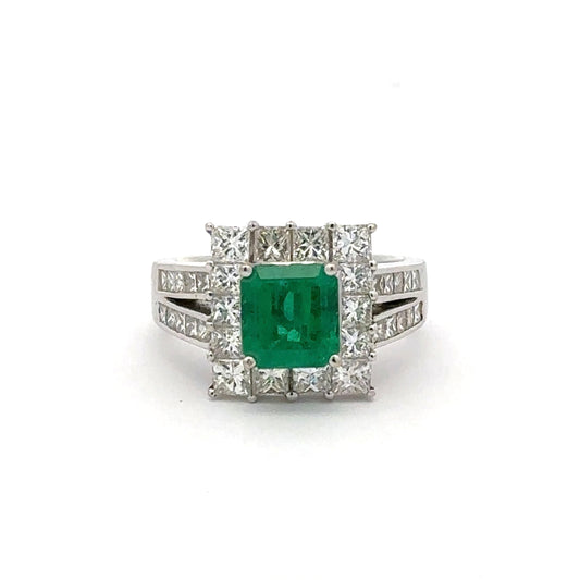 Ring with a green gemstone and diamond accents on a white background
