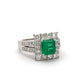 Ring with a green gemstone and diamond accents on a white background