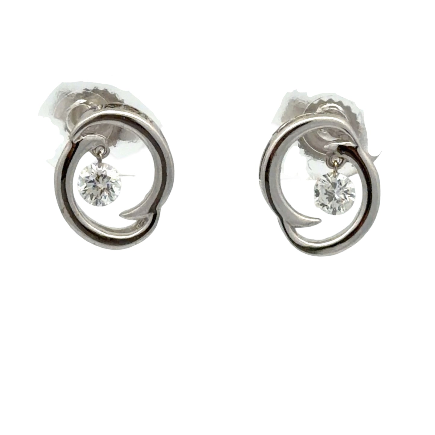 Pair of white gold earrings on white background with 1 floating round diamond in each earring