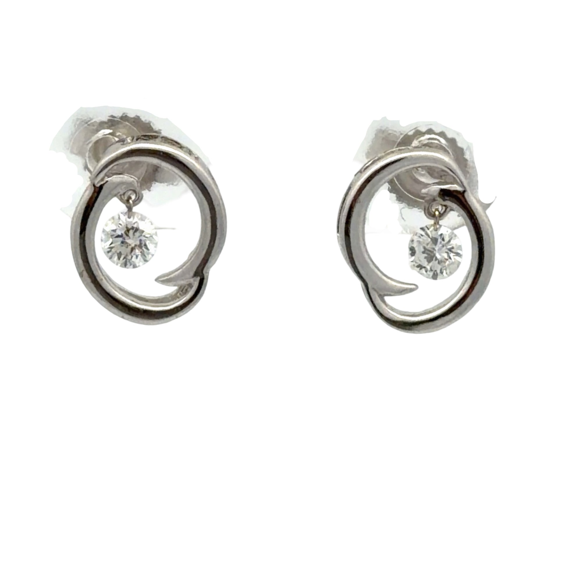 Pair of white gold earrings on white background with 1 floating round diamond in each earring