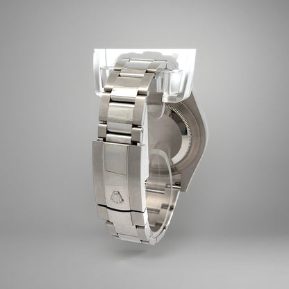 Silver watch band with clasp on a gray background
