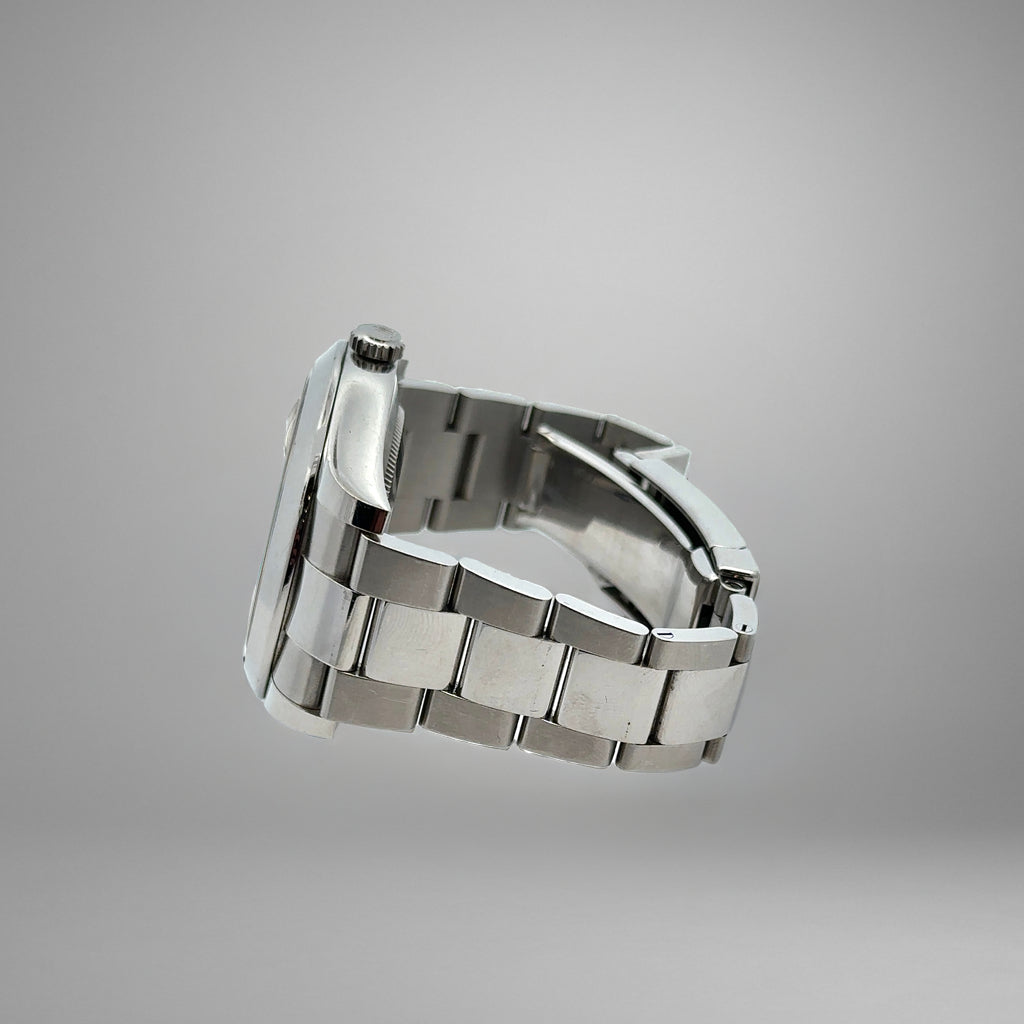 Silver watch band on a gray background