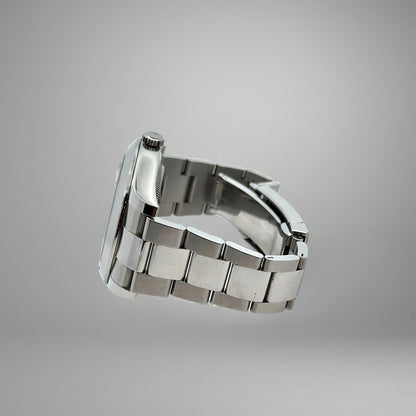 Silver watch band on a gray background