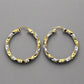 two-toned twist hoops lying flat