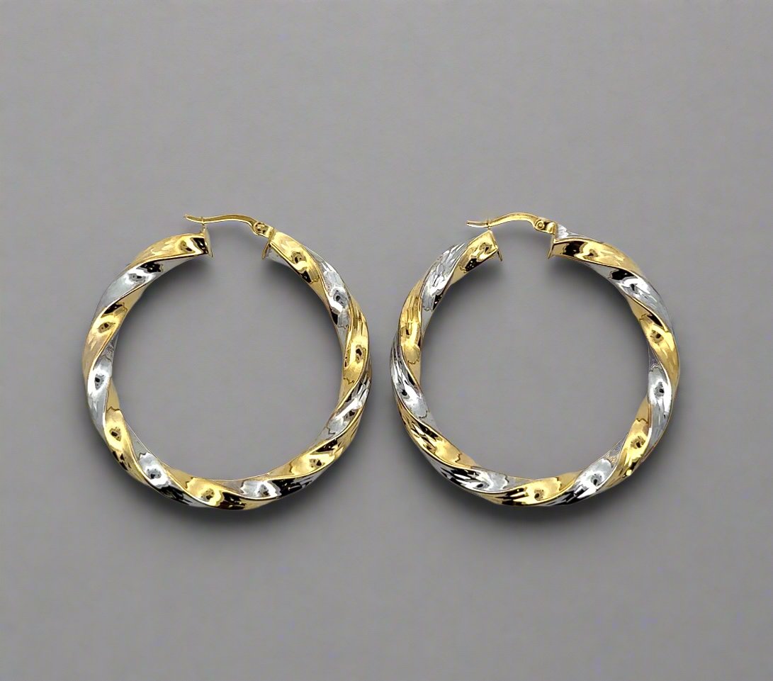 two-toned twist hoops lying flat