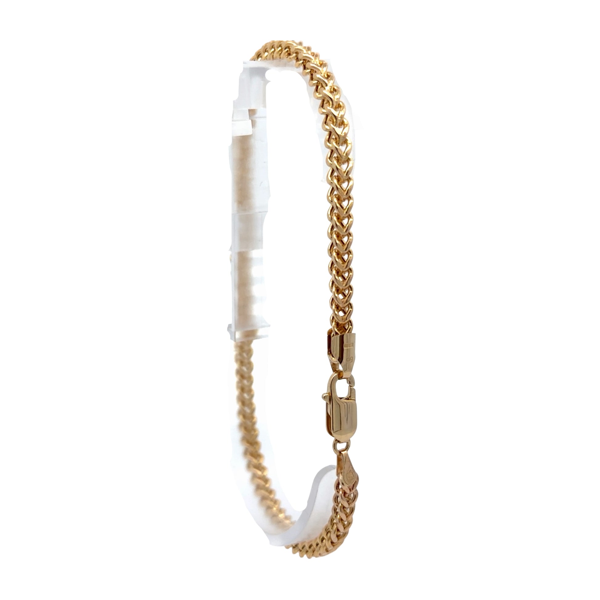 A gold-toned Franco-style anklet displayed on a white plastic hanger against a plain white background.