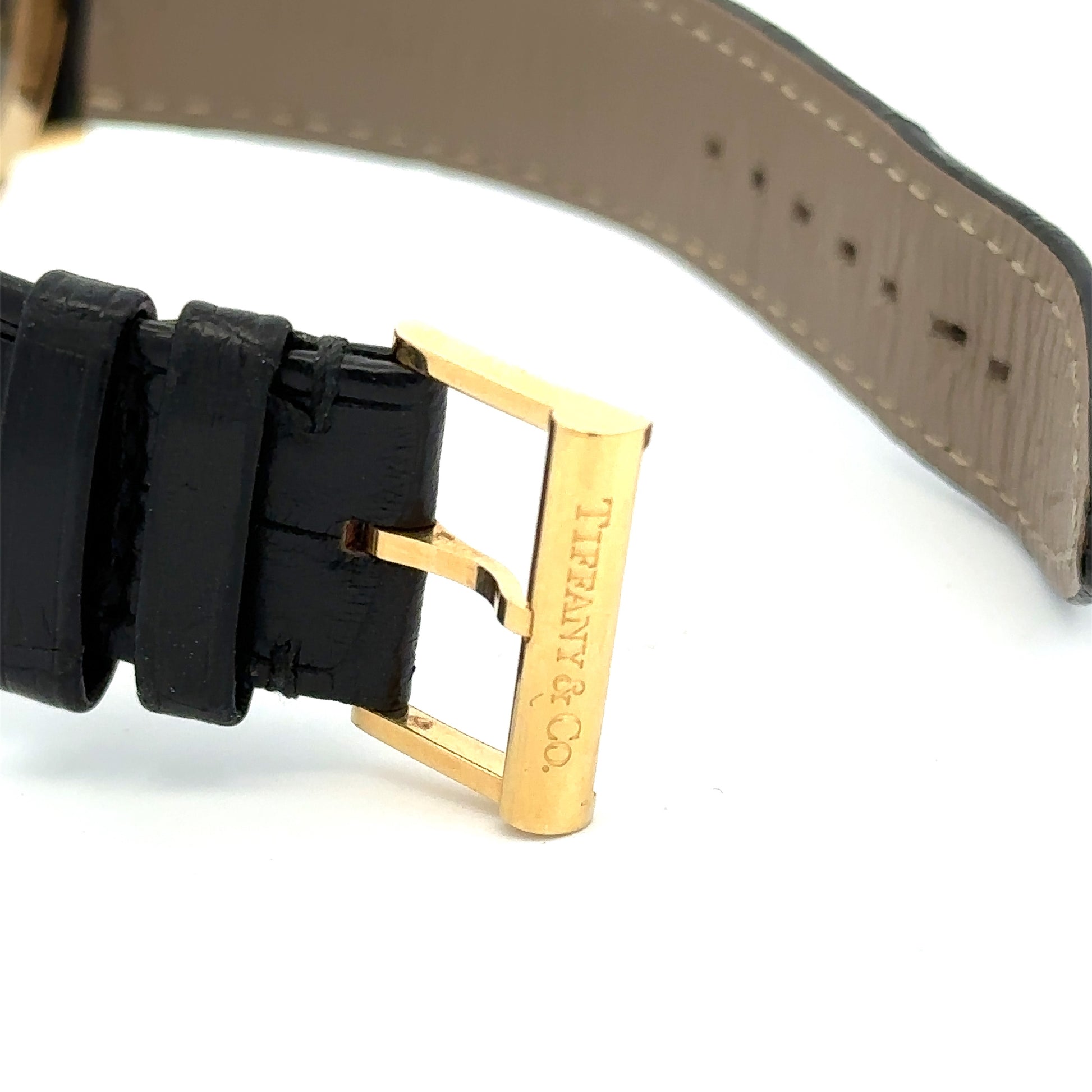 Tiffany & Co watch clasp. Scratches on 18K yellow gold. Wear on the leather band. Inside of the leather band is grey.