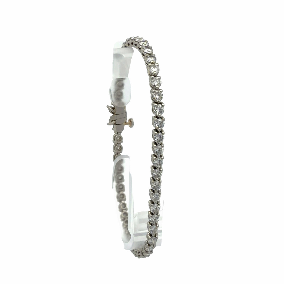 Side view of 18K white gold natural diamond tennis bracelet showing round diamond links and clasp