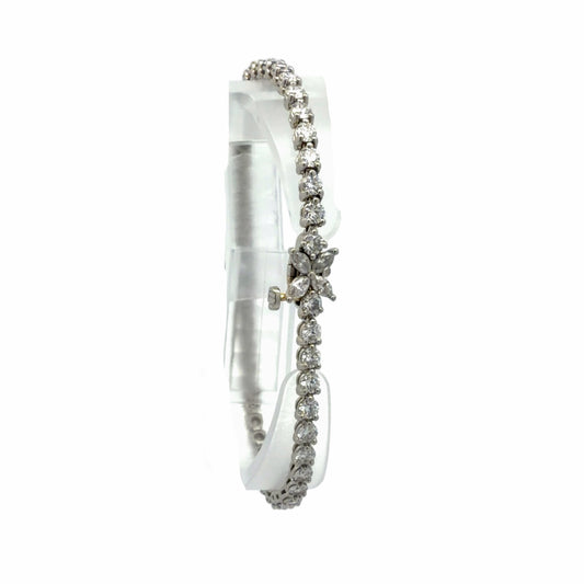 18K white gold natural diamond tennis bracelet featuring round diamonds and a marquise-shaped diamond floral accent