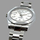 Silver watch with a white face on a gray background