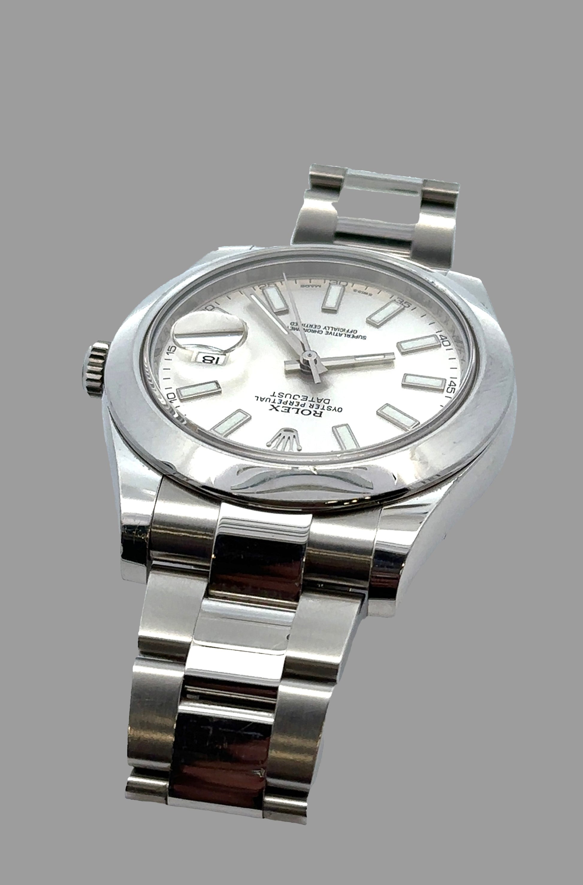 Silver watch with a white face on a gray background