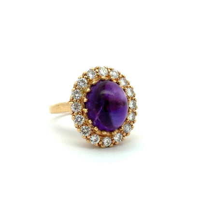 Diagonal view of purple oval amethyst ring and diamonds around the stone