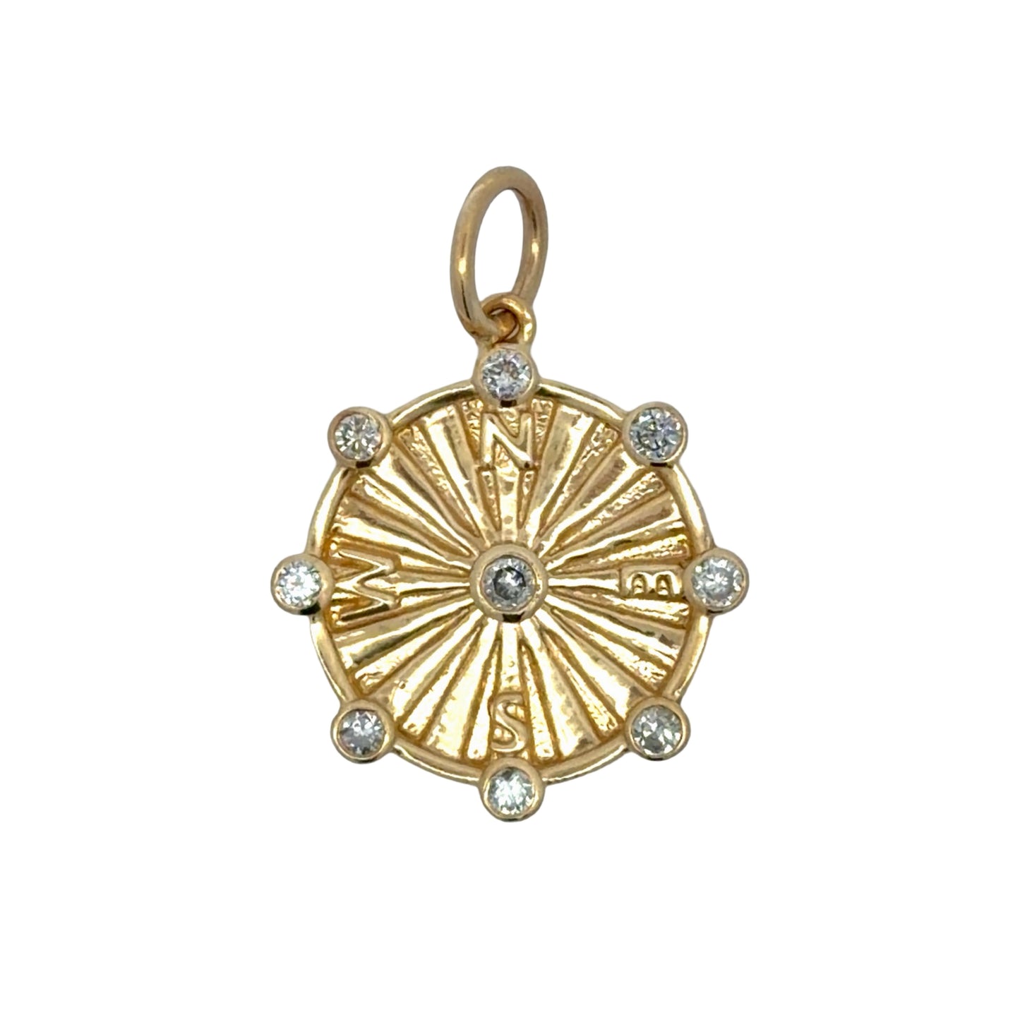 Gold compass pendant with diamond accents on a white background