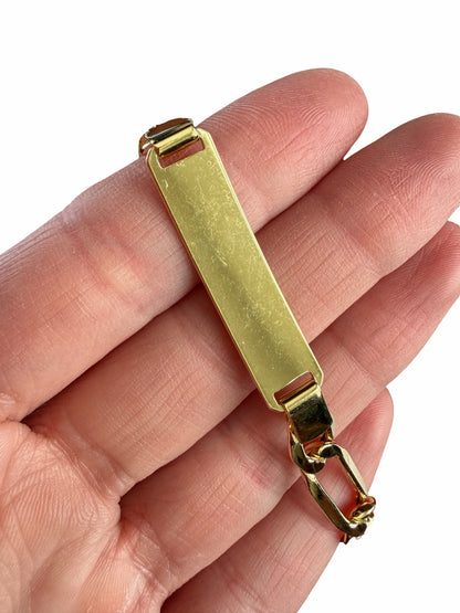 14K yellow gold ID bracelet, close-up of ID plate with visible surface scratches