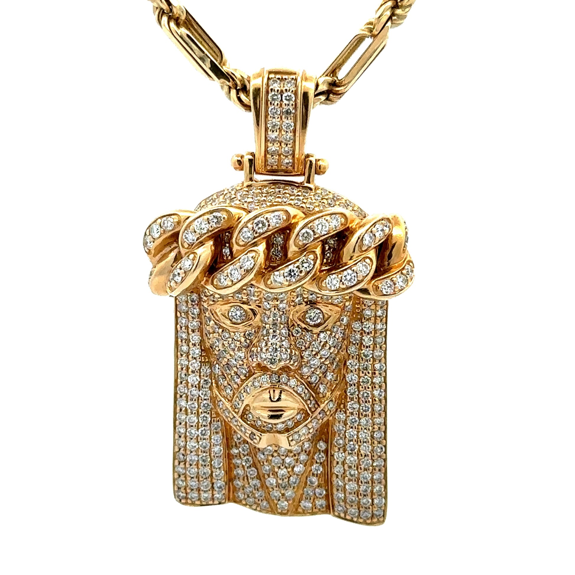 close up of diamond jesus head pendant in yellow gold