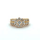 Gold ring with diamond accents on a white background