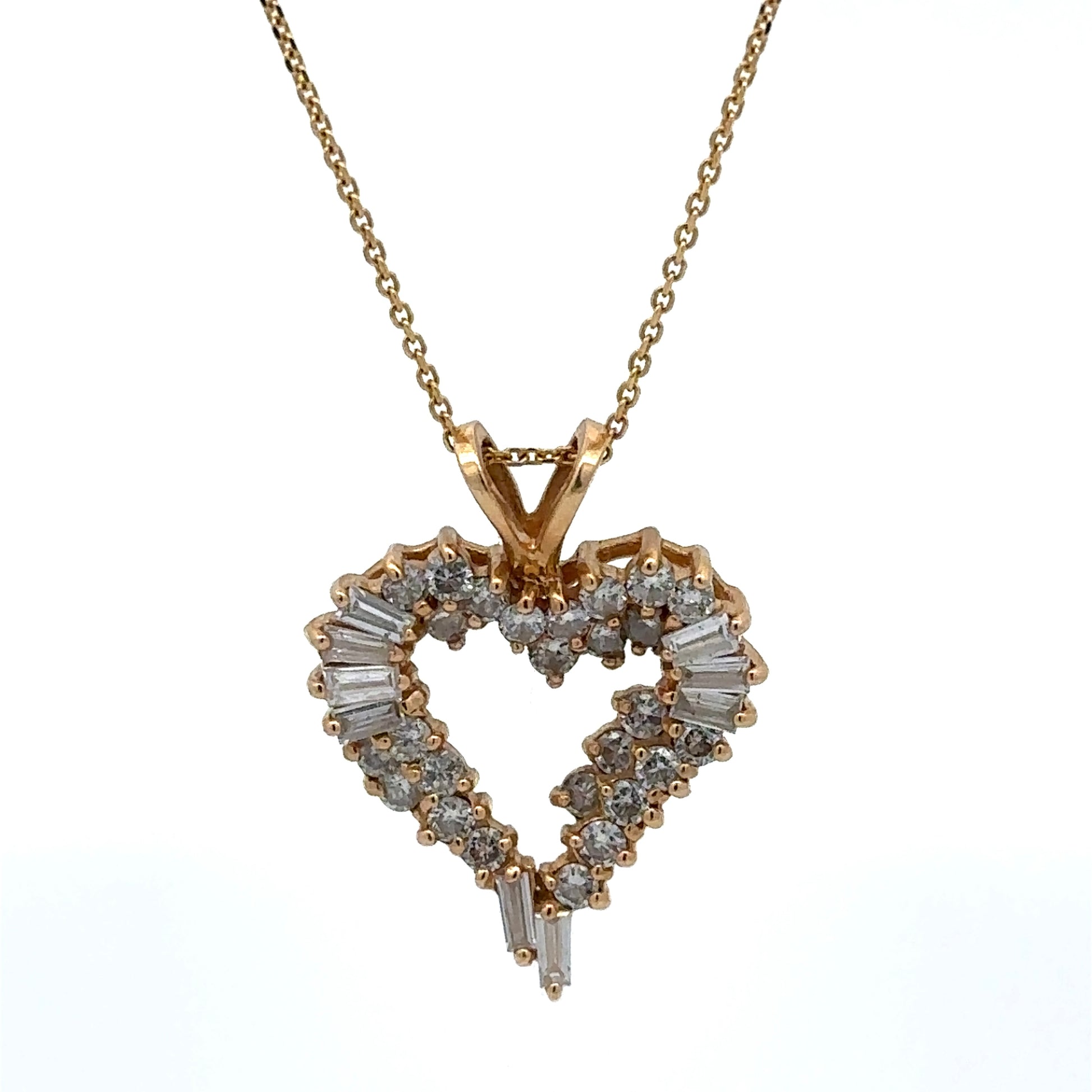 Heart-shaped diamond pendant on a gold chain against a white background