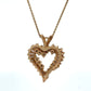 Gold heart-shaped pendant necklace on a white background