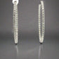 Front of large white gold diamond hoops with diamonds on front and inside