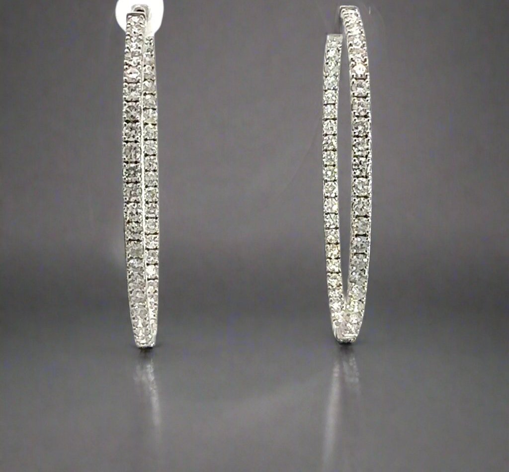 Front of large white gold diamond hoops with diamonds on front and inside