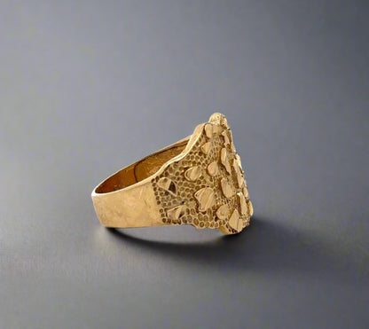 Side of yellow gold nugget ring with some scratches 