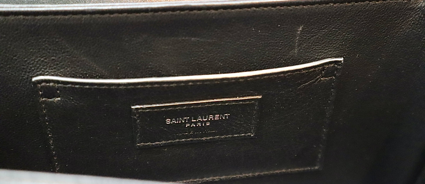 Inside of bag showing card flap with Saint Laurent logo. Scuff mark shown.