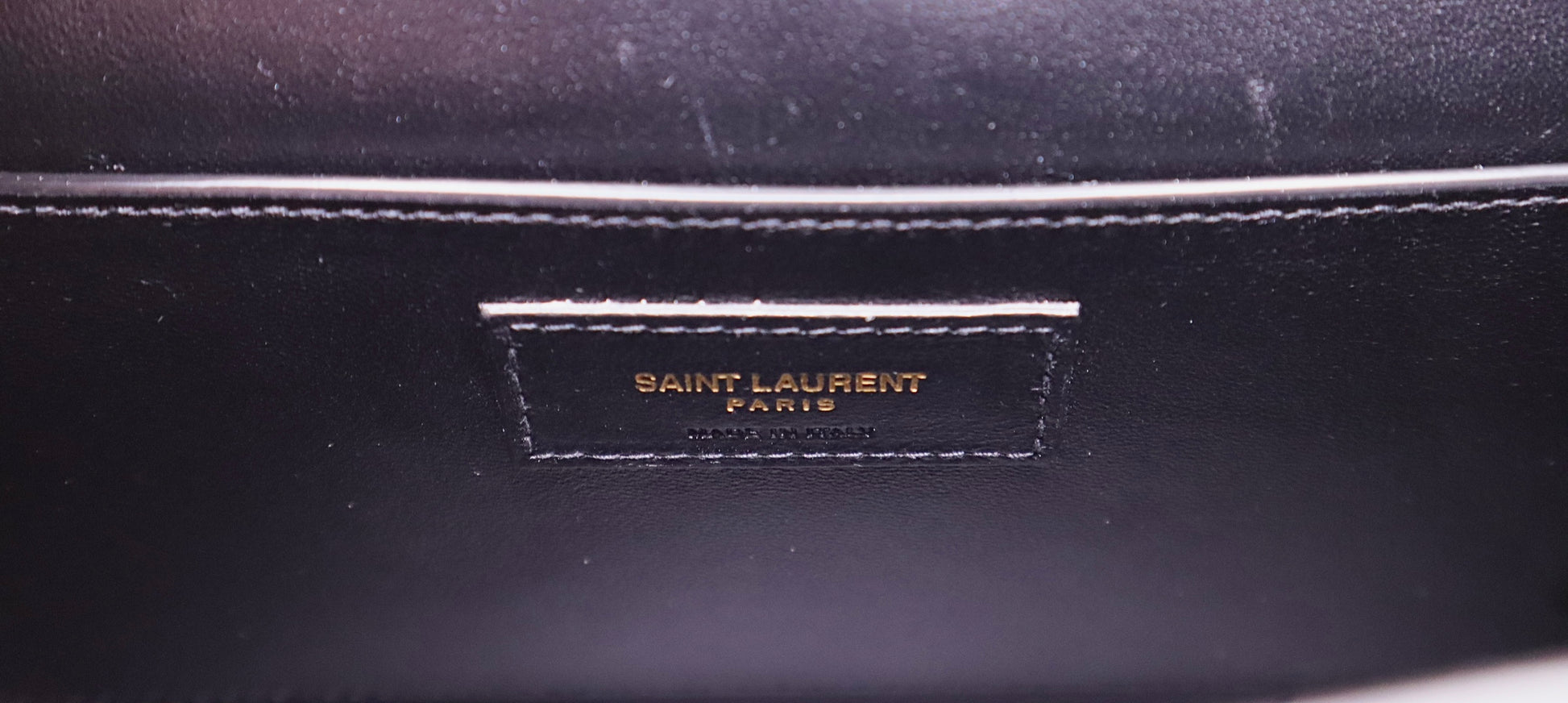 Saint laurent leather logo on inside with scuff marks above.