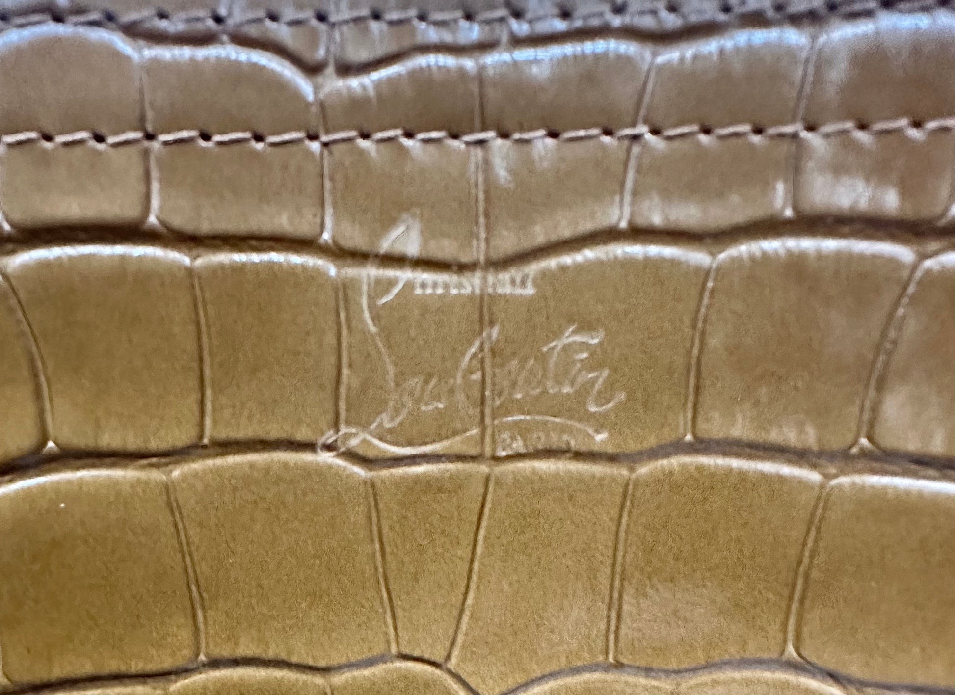 Christian Louboutin stamp on outside of purse
