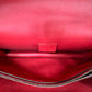Close up of 1 of the compartments inside red leather